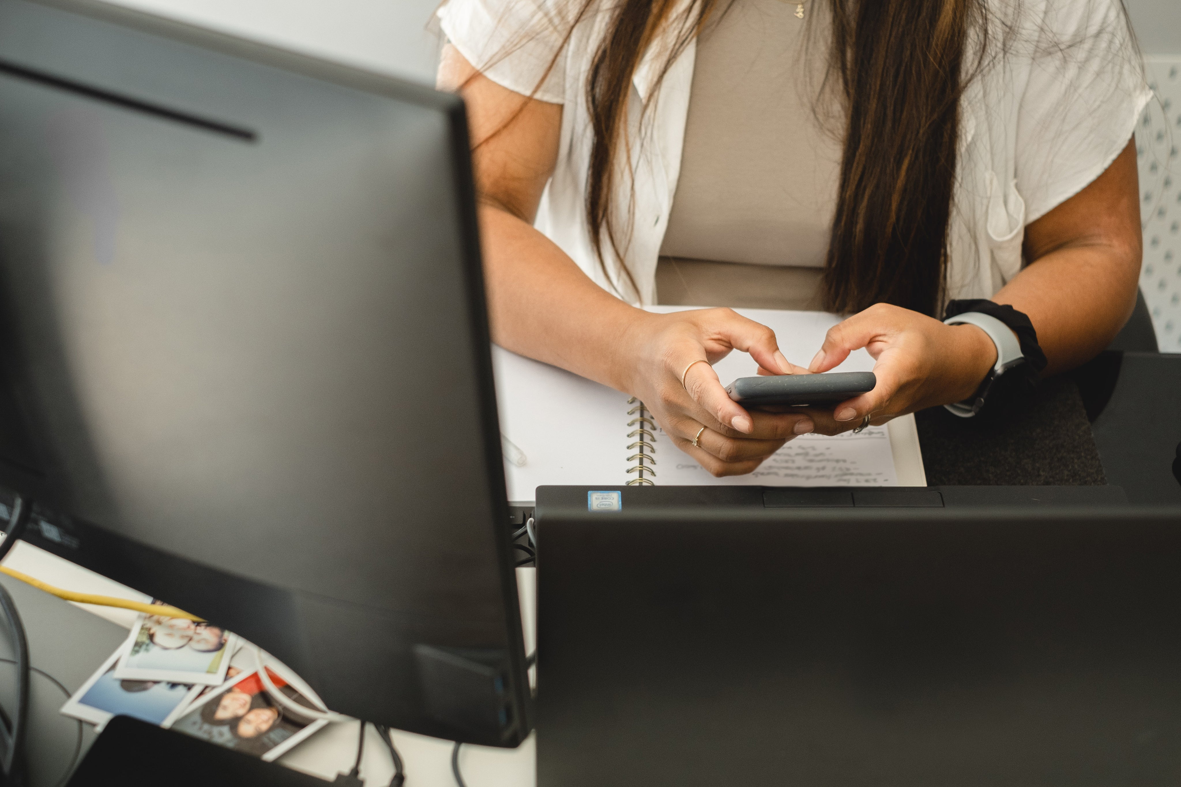 holding-phone-with-both-hands-while-sitting-at-desk.jpg